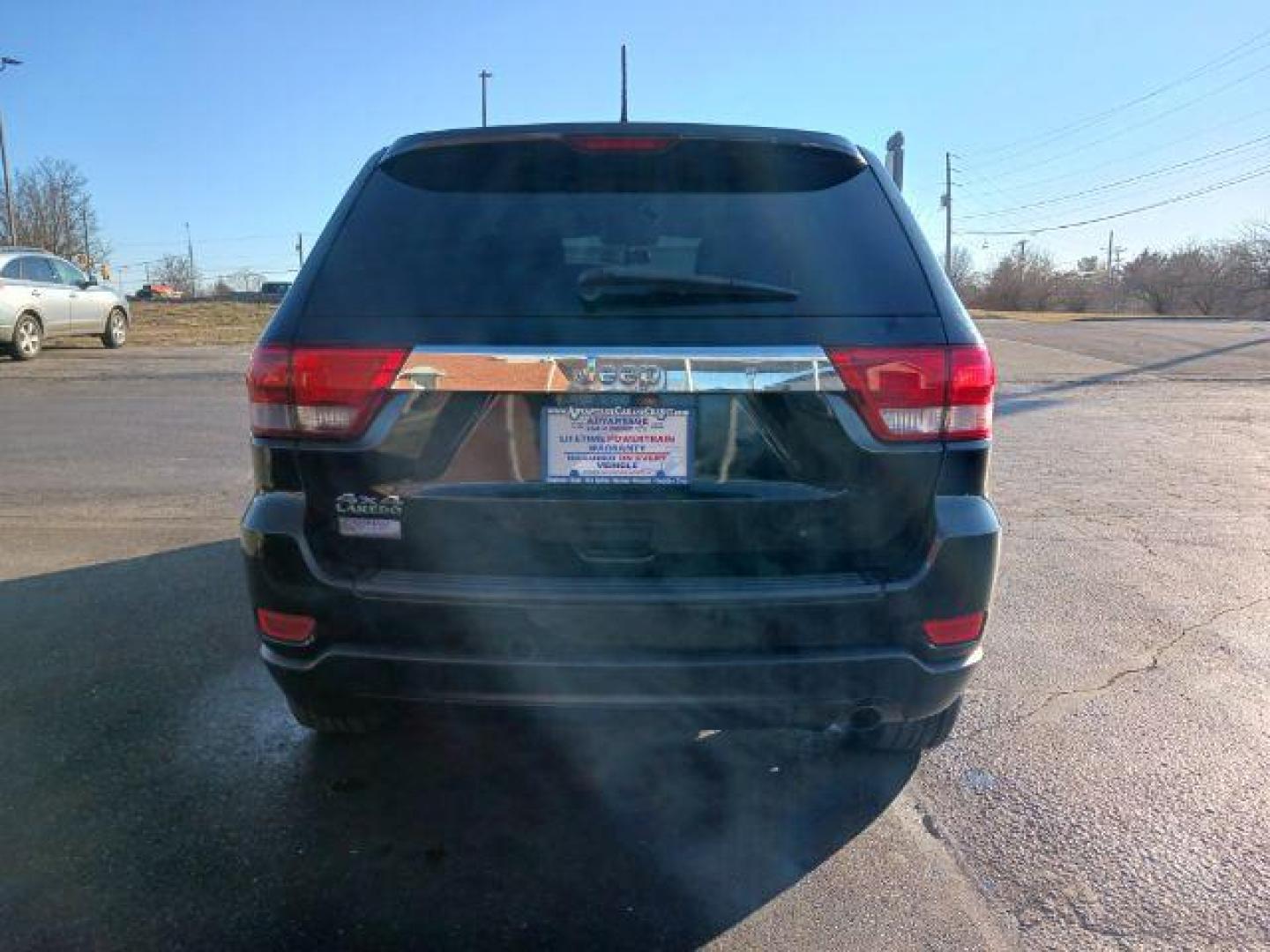 2012 Brilliant Black Crystal Pearl Jeep Grand Cherokee Laredo 4WD (1C4RJFAG1CC) with an 3.6L V6 DOHC 24V engine, 5-Speed Automatic transmission, located at 1099 N County Rd 25A, Troy, OH, 45373, (937) 908-9800, 40.057079, -84.212883 - Photo#5