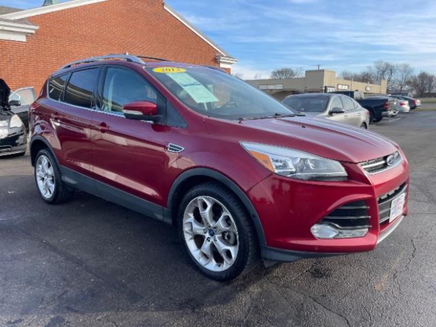 2013 Ruby Red Metallic Tinted Ford Escape Titanium 4WD (1FMCU9J92DU) with an 2.0L L4 DOHC 16V engine, 6-Speed Automatic transmission, located at 880 E. National Road, Vandalia, OH, 45377, (937) 908-9800, 39.891918, -84.183594 - Photo#0