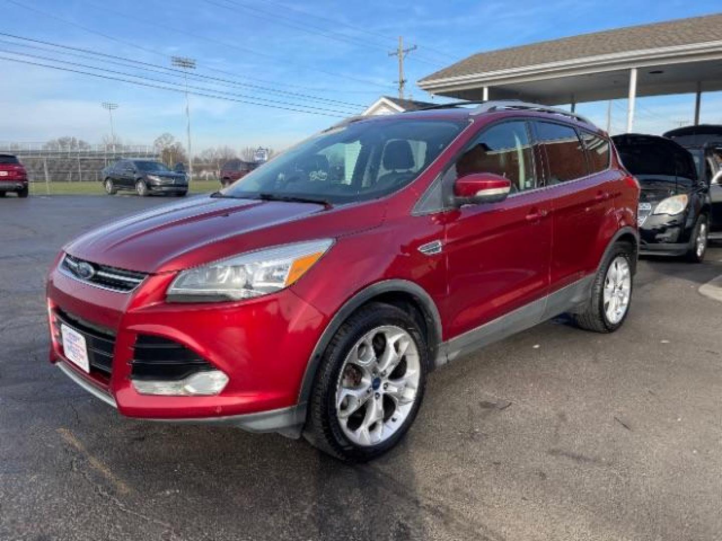 2013 Ruby Red Metallic Tinted Ford Escape Titanium 4WD (1FMCU9J92DU) with an 2.0L L4 DOHC 16V engine, 6-Speed Automatic transmission, located at 880 E. National Road, Vandalia, OH, 45377, (937) 908-9800, 39.891918, -84.183594 - Photo#1