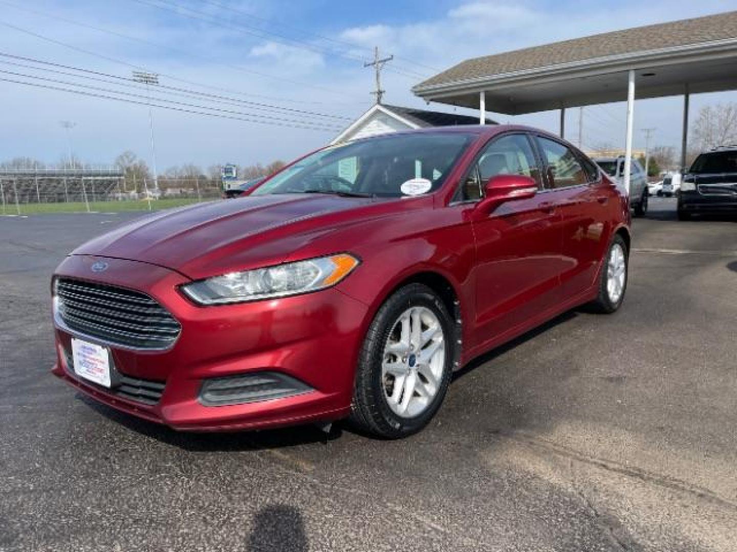 2013 Ruby Red Met Tinted CC Ford Fusion SE (3FA6P0H7XDR) with an 2.5L L4 DOHC 16V engine, located at 1099 N County Rd 25A, Troy, OH, 45373, (937) 908-9800, 40.057079, -84.212883 - Photo#1