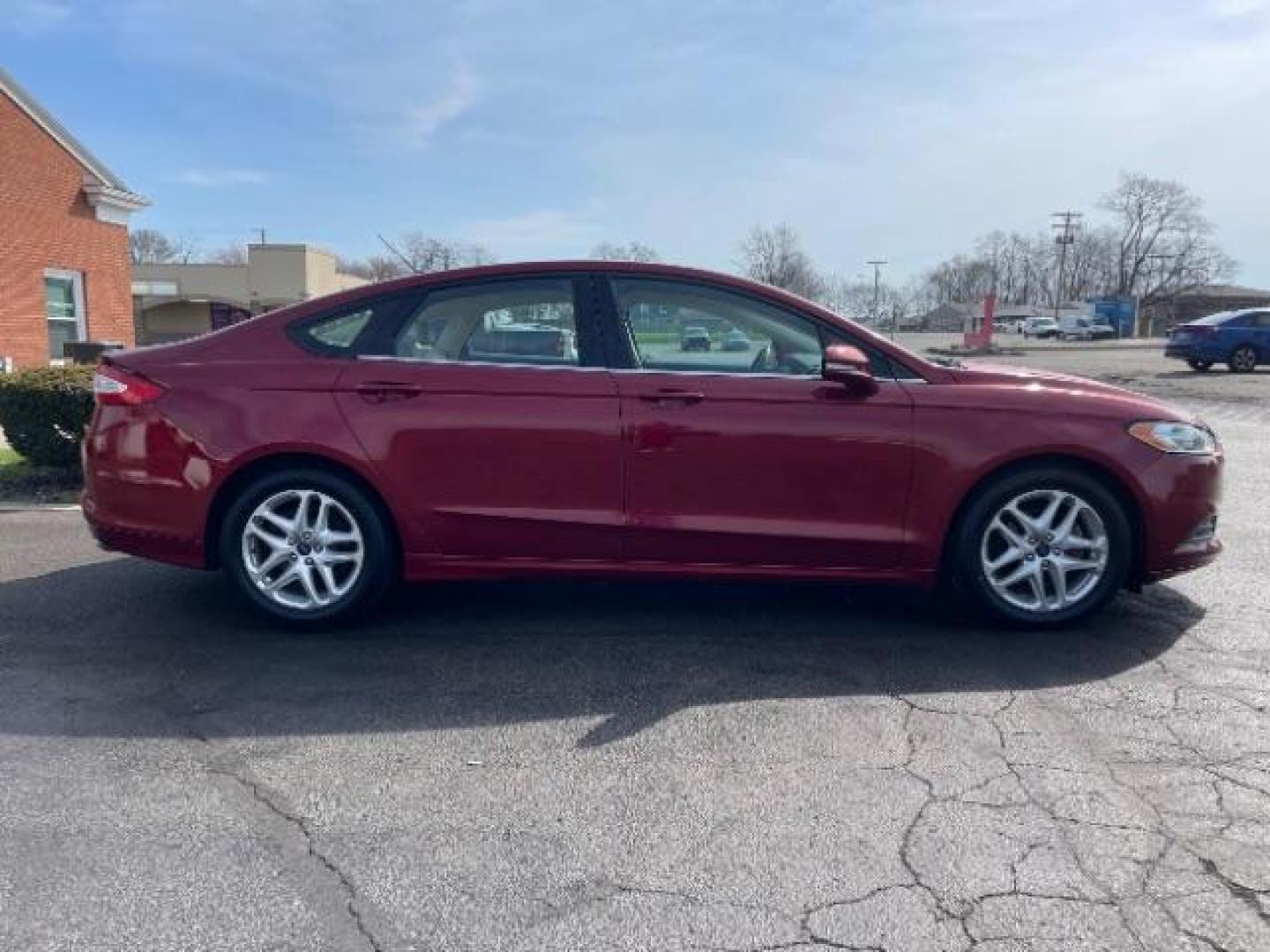 2013 Ruby Red Met Tinted CC Ford Fusion SE (3FA6P0H7XDR) with an 2.5L L4 DOHC 16V engine, located at 1099 N County Rd 25A, Troy, OH, 45373, (937) 908-9800, 40.057079, -84.212883 - Photo#3