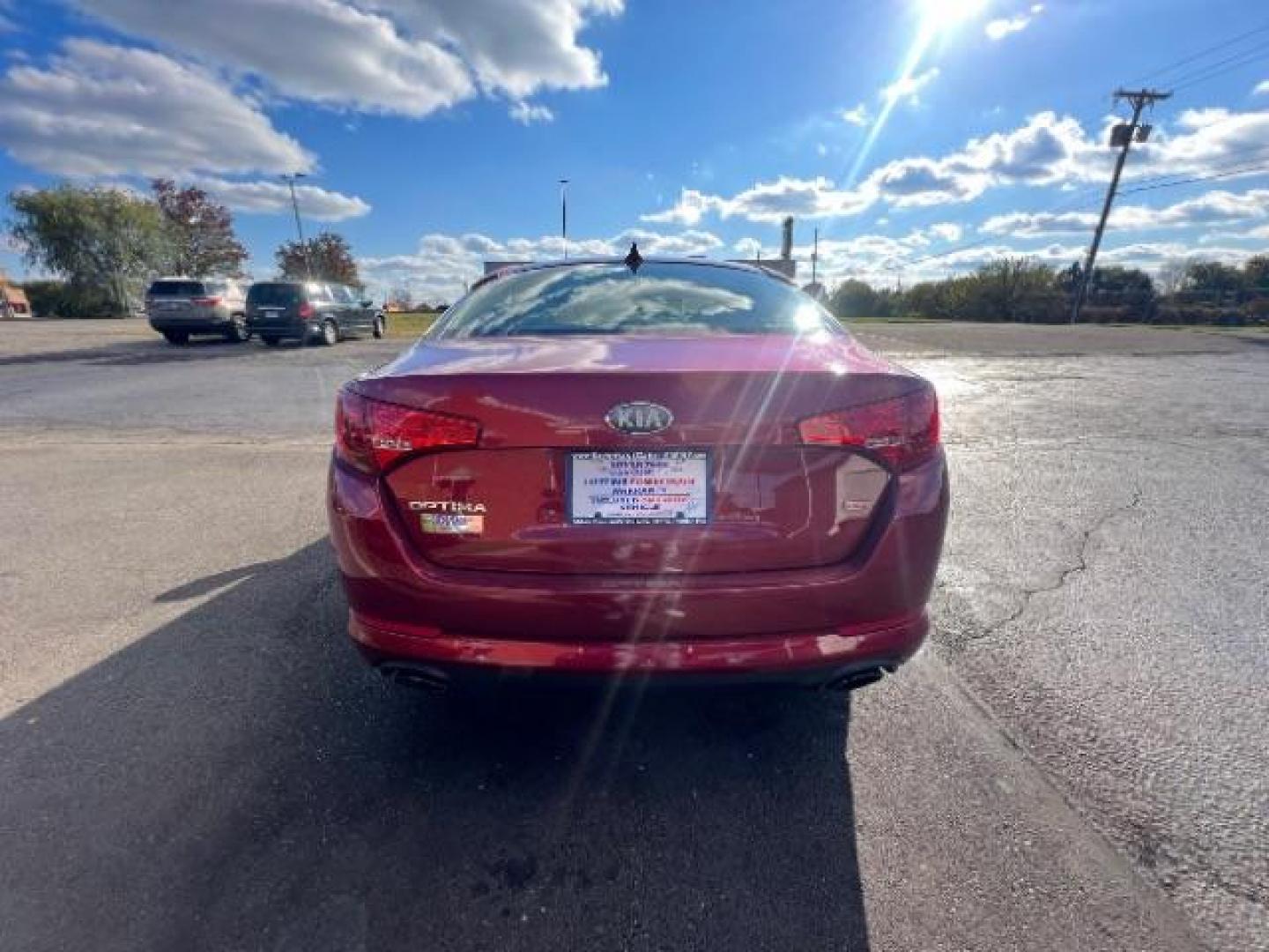 2013 Remington Red Metallic Kia Optima LX AT (5XXGM4A71DG) with an 2.4L L4 DOHC 16V engine, 6-Speed Automatic transmission, located at 1230 East Main St, Xenia, OH, 45385, (937) 908-9800, 39.688026, -83.910172 - Photo#4