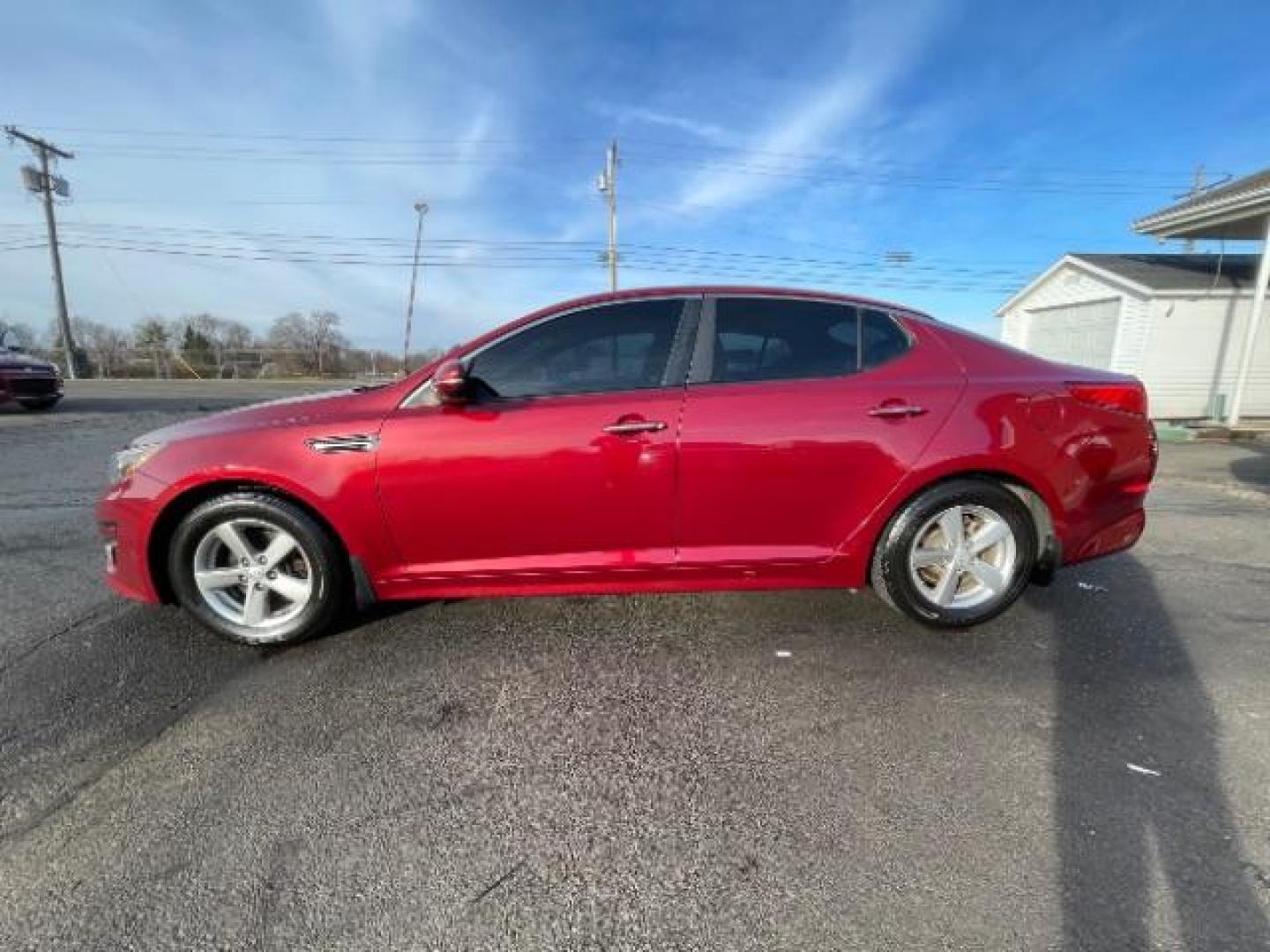 2014 Remington Red Metallic Kia Optima LX (5XXGM4A72EG) with an 2.4L L4 DOHC 16V engine, 6-Speed Automatic transmission, located at 401 Woodman Dr, Riverside, OH, 45431, (937) 908-9800, 39.760899, -84.123421 - Photo#4