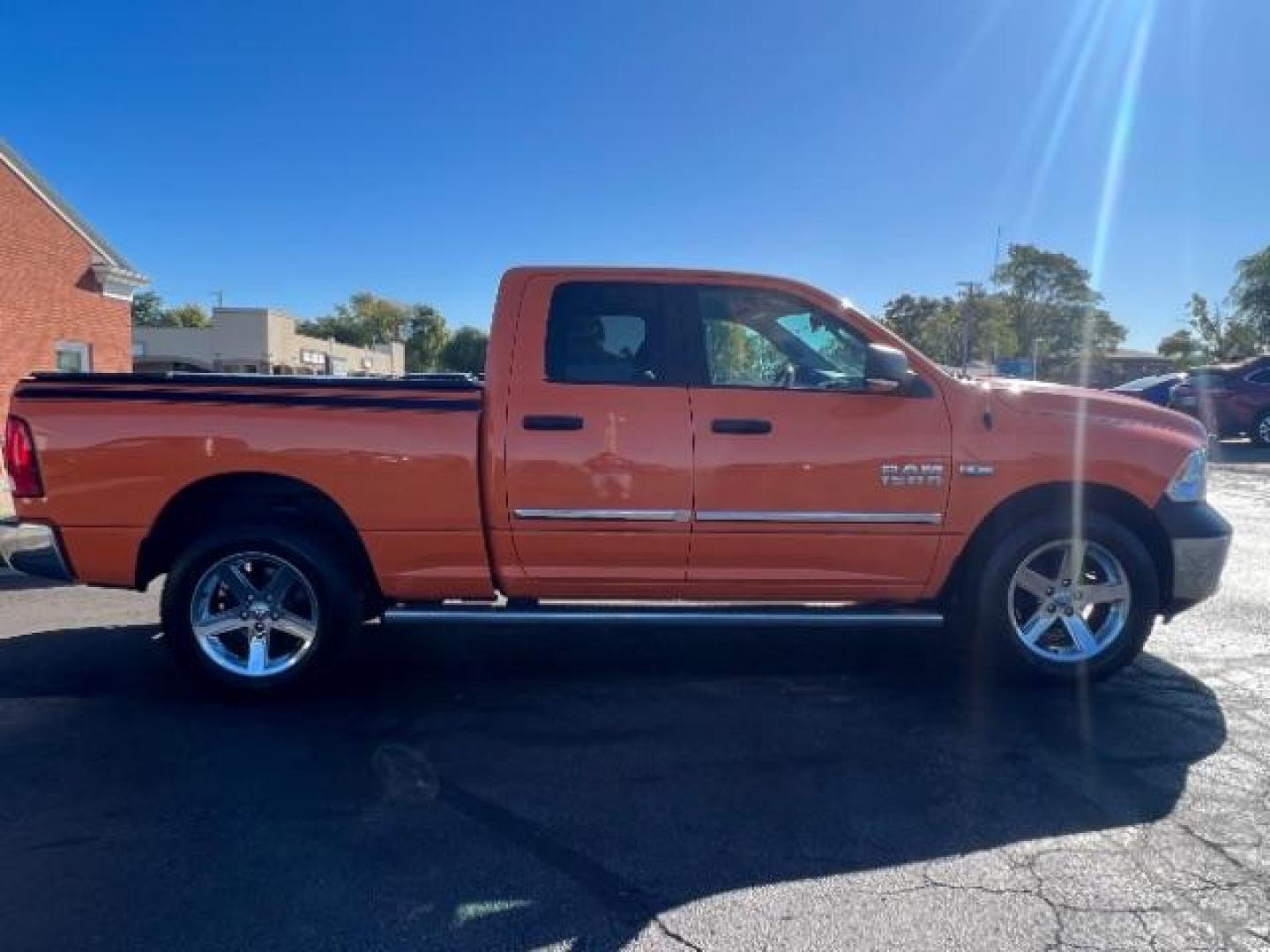 2016 Low Vol Omaha Orange RAM 1500 SLT Quad Cab 4WD (1C6RR7GT3GS) with an 5.7L V8 OHV 16V engine, 8-Speed Automatic transmission, located at 1099 N County Rd 25A, Troy, OH, 45373, (937) 908-9800, 40.057079, -84.212883 - Photo#5