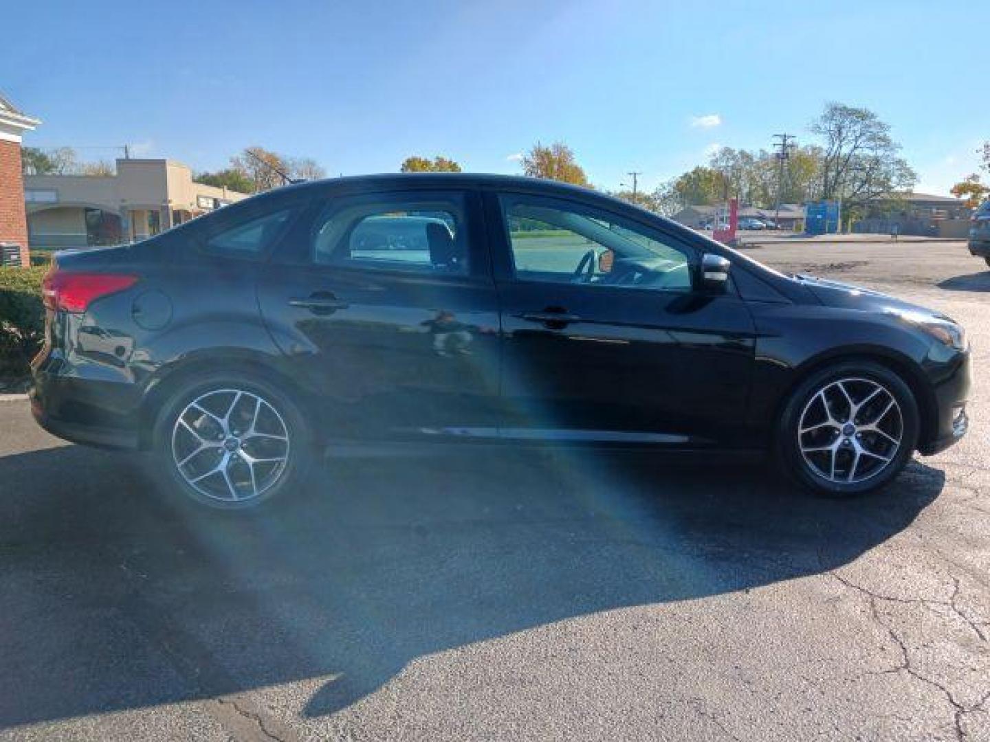 2017 Shadow Black Ford Focus SEL Sedan (1FADP3H2XHL) with an 2.0L L4 DOHC 16V engine, located at 880 E. National Road, Vandalia, OH, 45377, (937) 908-9800, 39.891918, -84.183594 - Photo#4