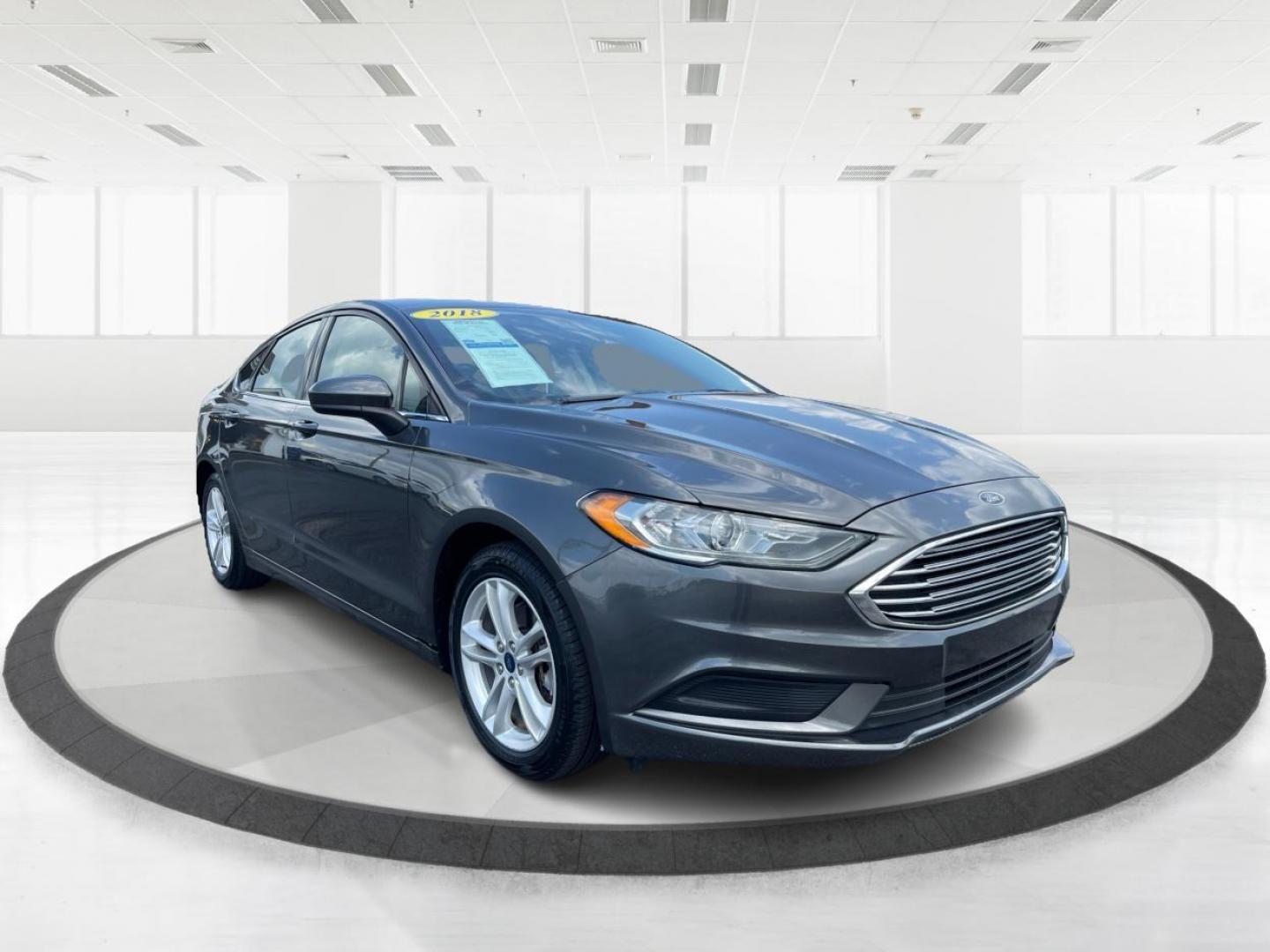 2018 Magnetic Metallic Ford Fusion SE (3FA6P0HD2JR) with an 1.5L L4 DOHC 16V engine, 6-Speed Automatic transmission, located at 1099 N County Rd 25A, Troy, OH, 45373, (937) 908-9800, 40.057079, -84.212883 - Photo#0